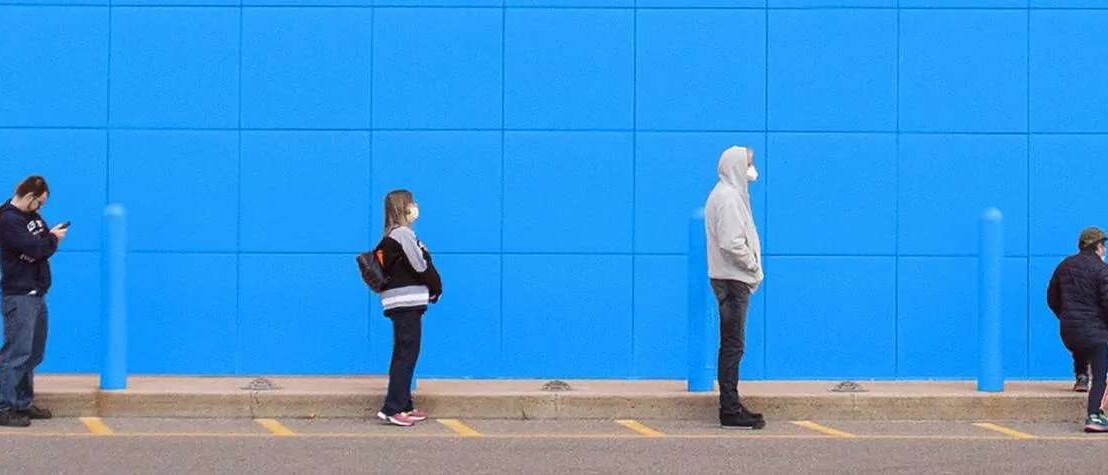 People standing in a line 6 feet apart