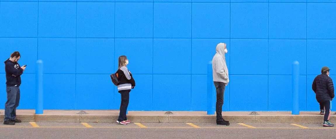 People standing in a line 6 feet apart